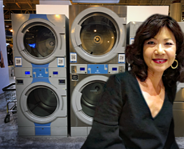 Tracey Sitting in Front of Washers and Dryers